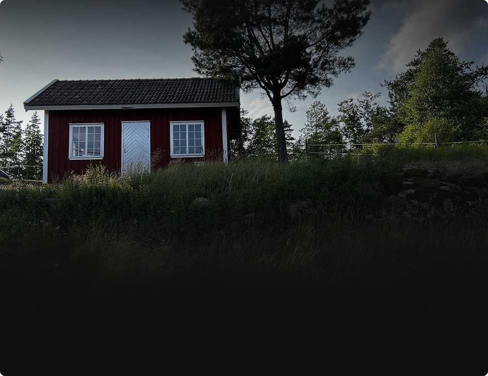 Red wooden house in a forest setting